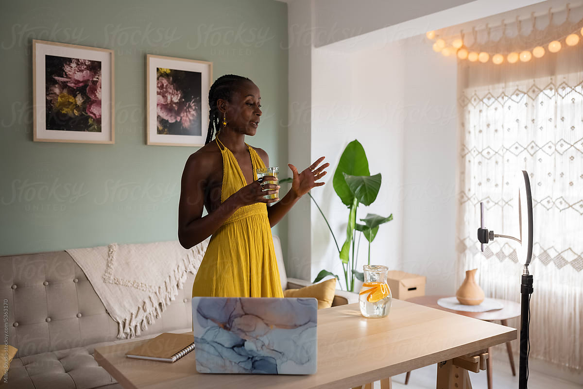 Black female blogger recording video in living room