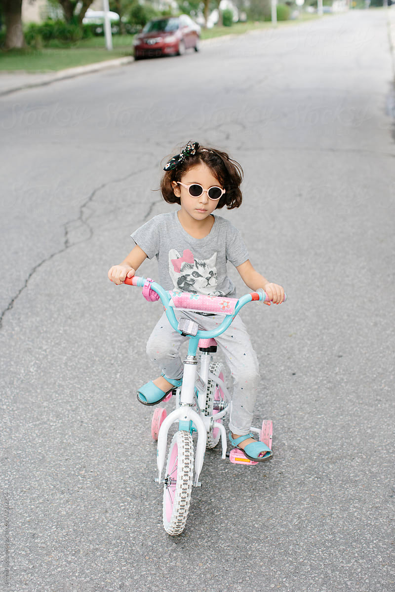 Kid on bike with sunglasses