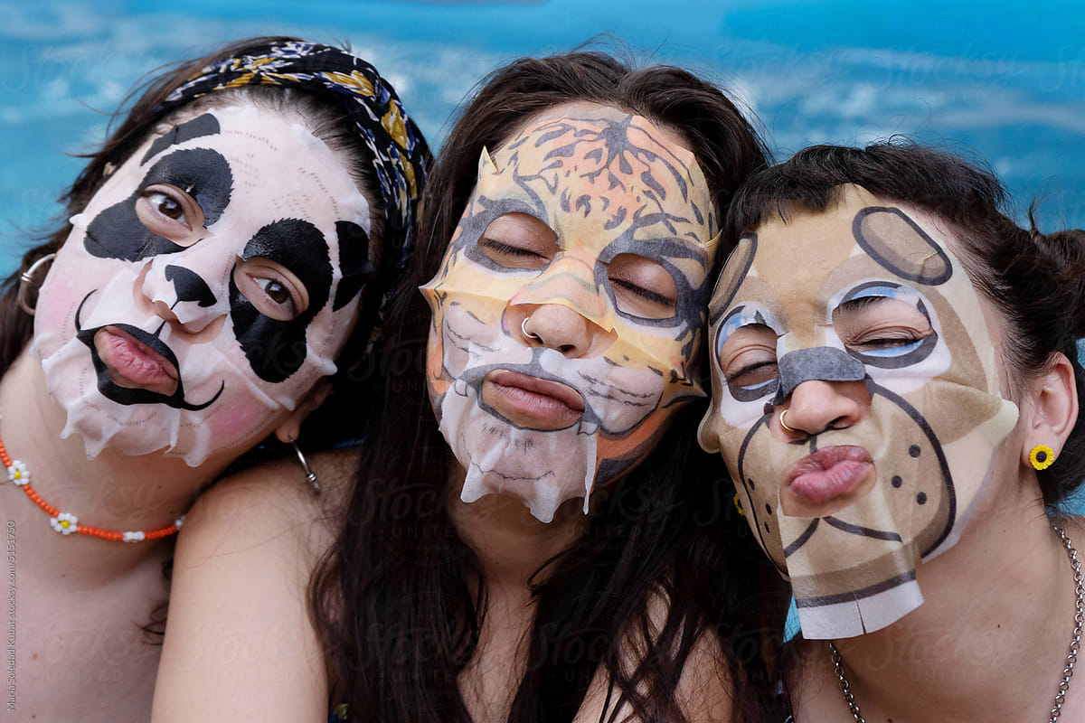 Women having fun wearing face beauty mask for skin care therapy