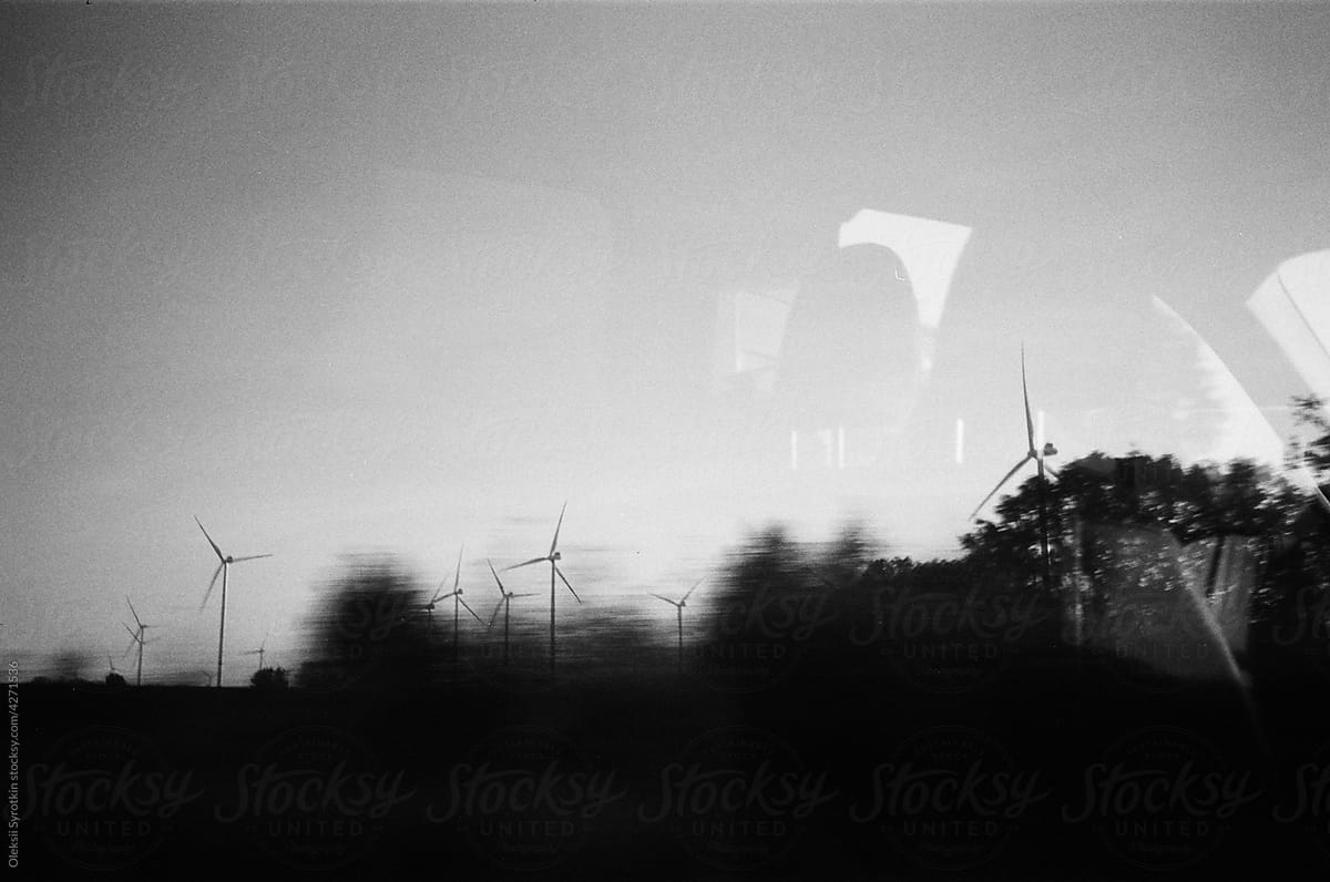 View from car window to wind turbines in countryside