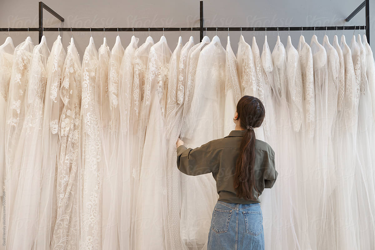 Fiancee choosing bridal gown in boutique