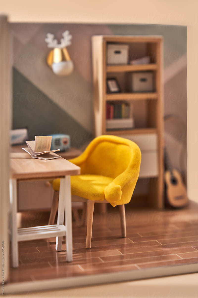 Miniature room with table and yellow chair