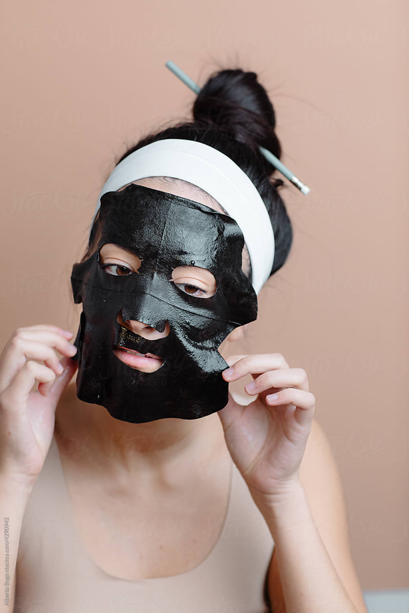 Young Girl Peeling Off Diy Facial Mask With Hands