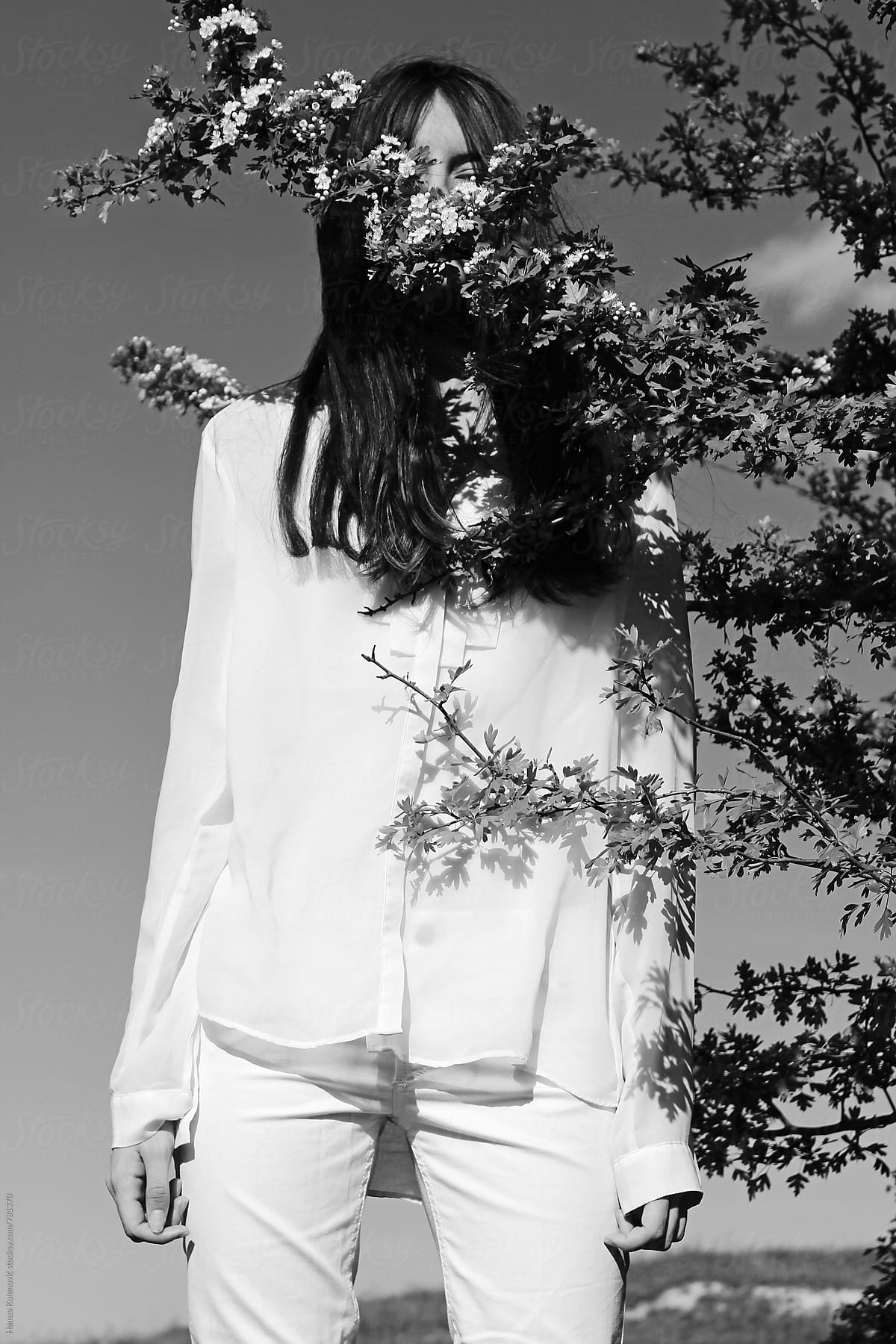 Artistic Black And White Photo Of A Girl Wearing White Clothes In Nature By Stocksy