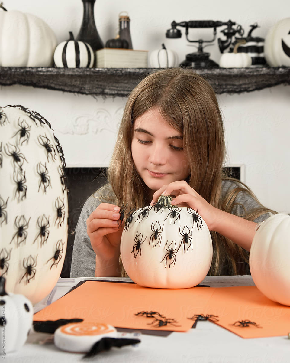 Child Decorating Halloween Pumpkin
