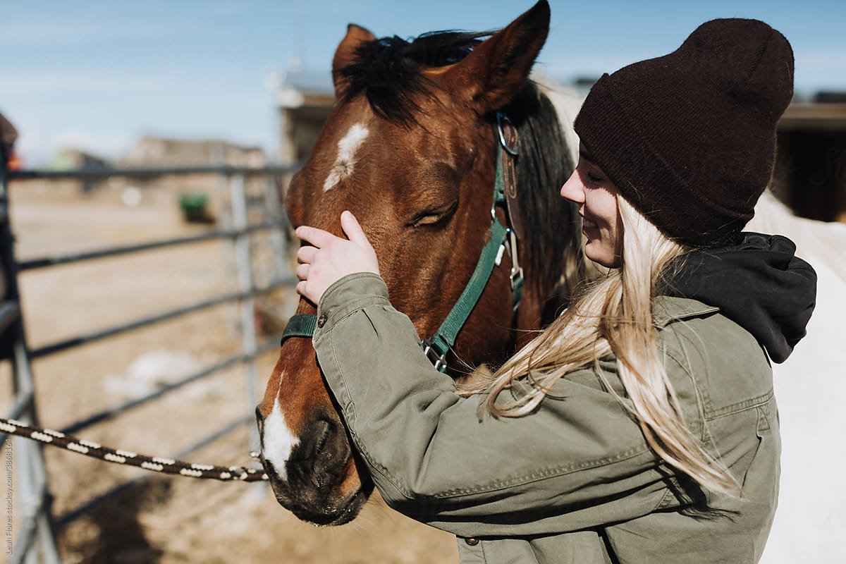 A Happy Rancher Pets Her Horse Lovingly