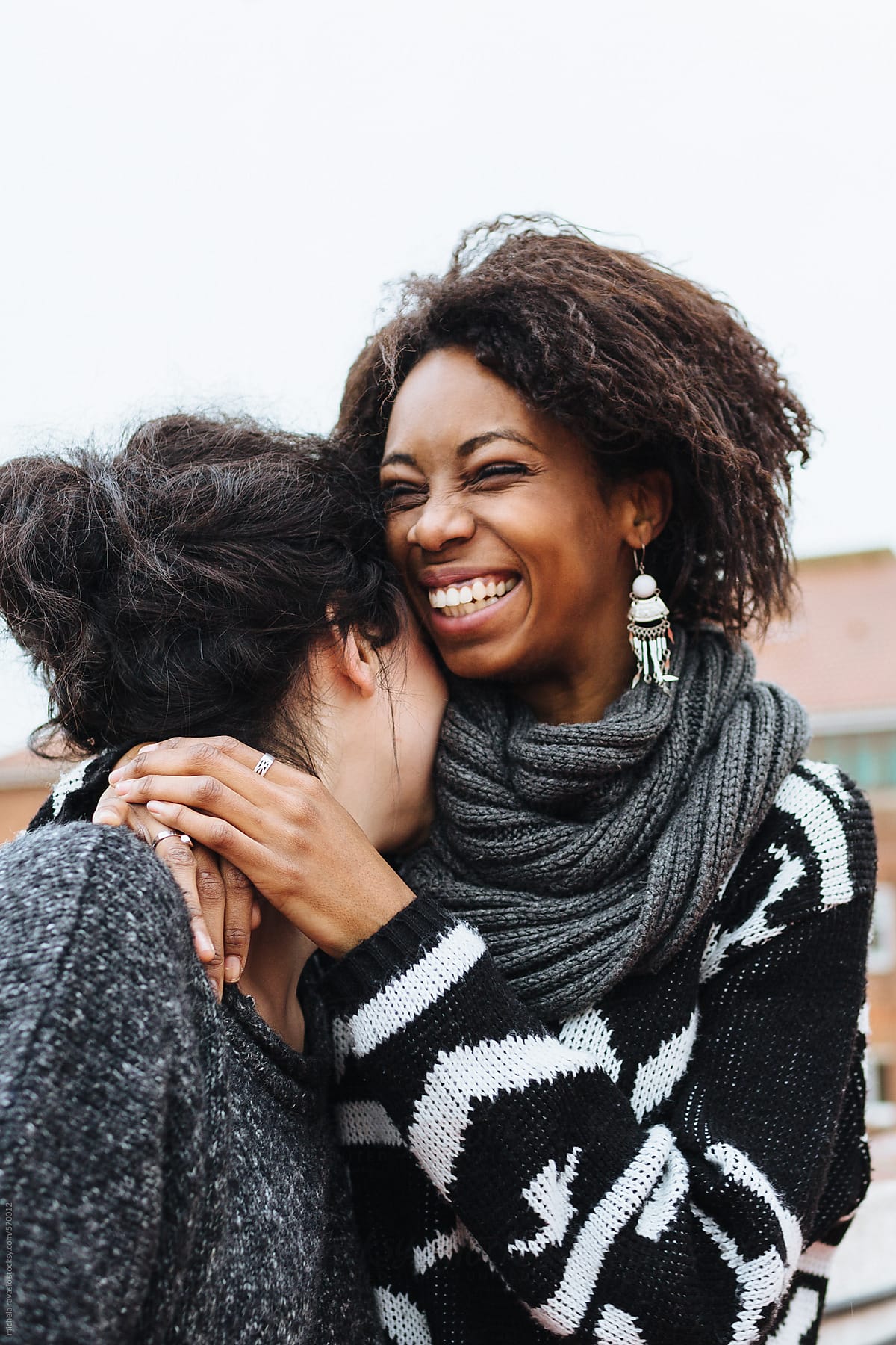 Two Happy Female Friends Hugging Outdoors By Stocksy Contributor Michela Ravasio Stocksy 