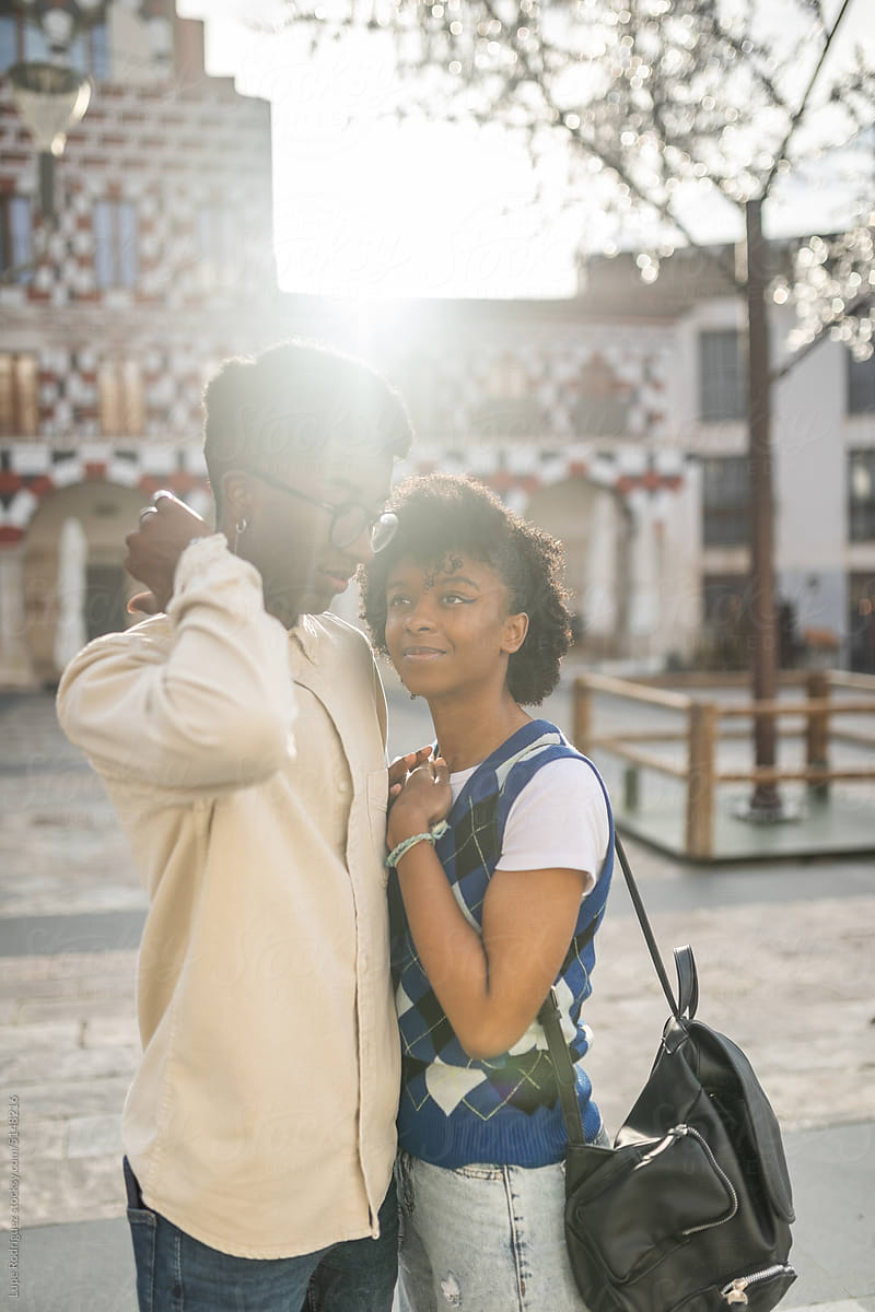 young black couple in love embracing in the city
