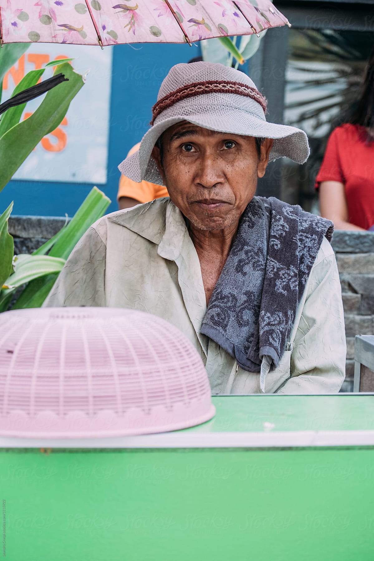 Indonesian old man preparing and selling typical food on the street