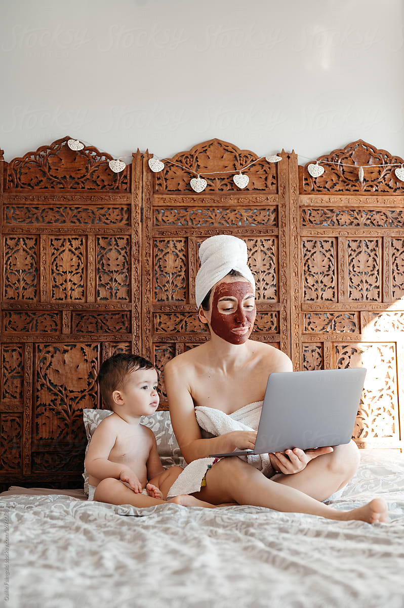 Mom with baby using laptop.