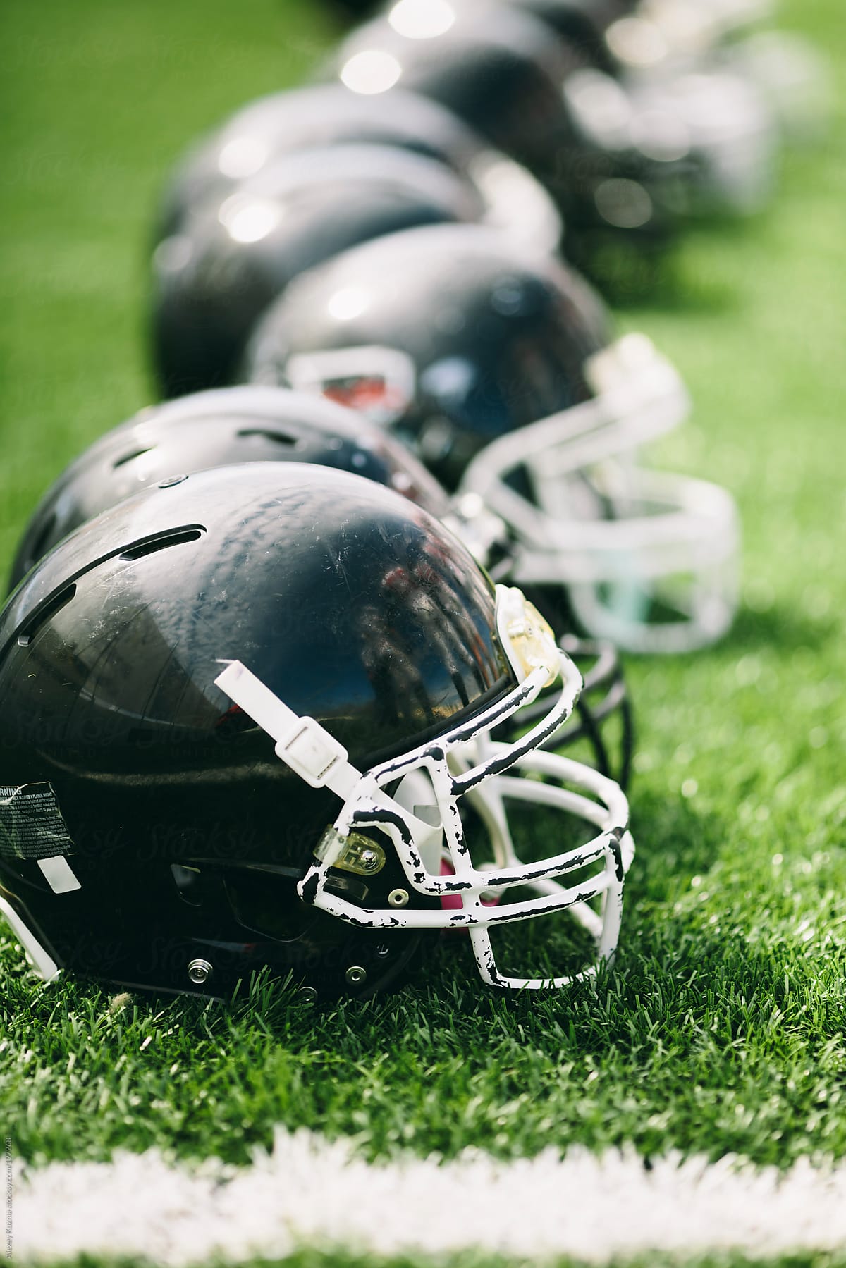 American football helmets on the green grass