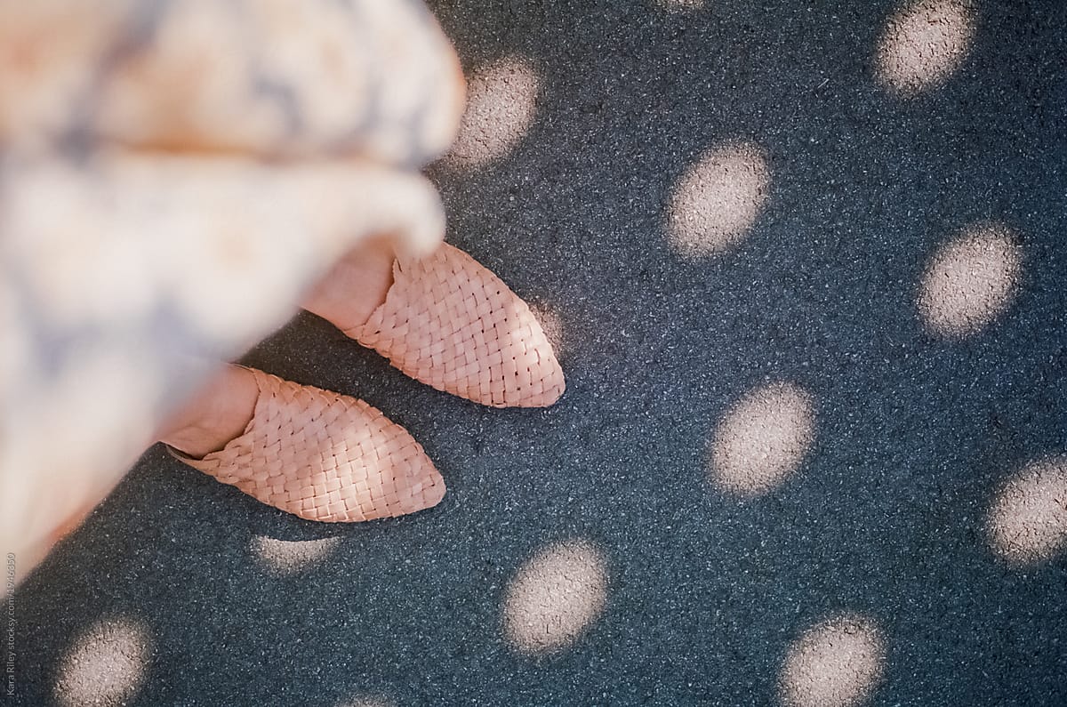 Female Feet on ground with shadows