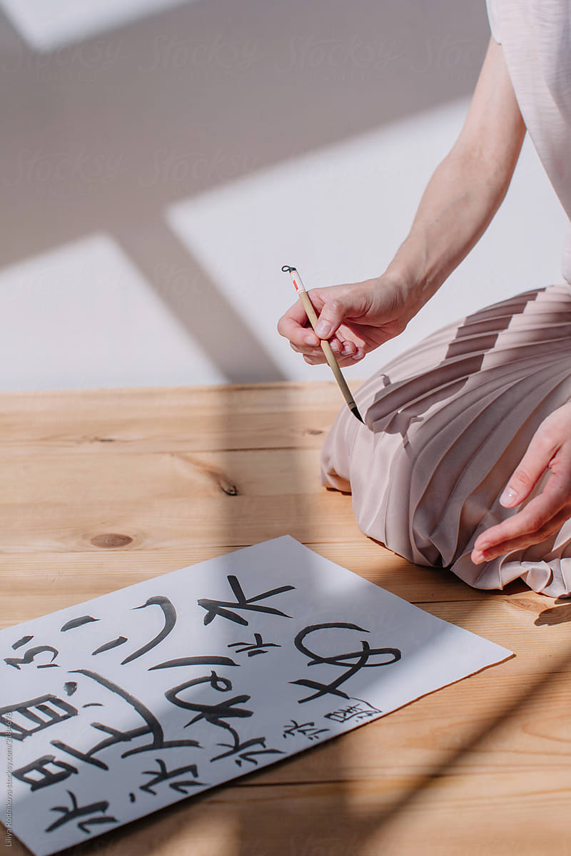 Unrecognizable female creating calligraphy