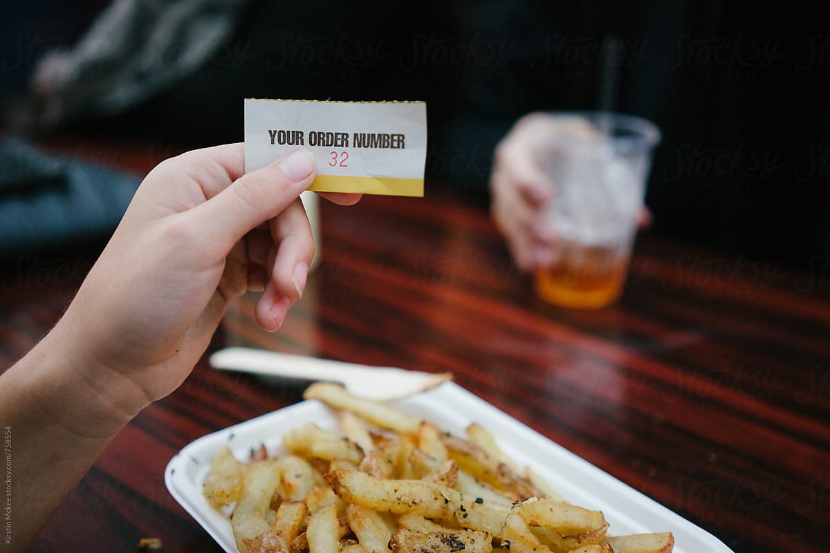 Holding up a ticket for food at a London pop up