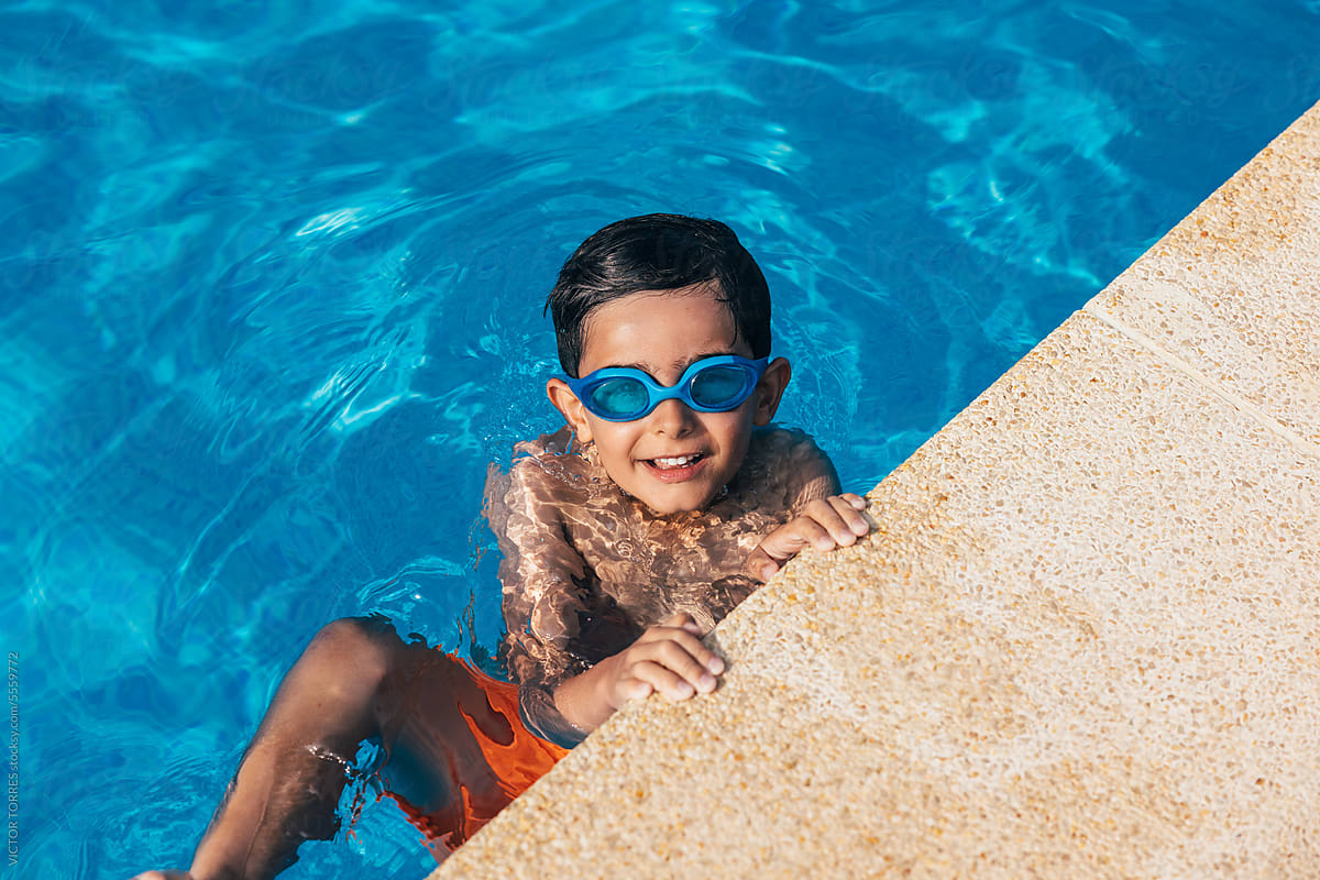 Cheerful boy in swimming pool