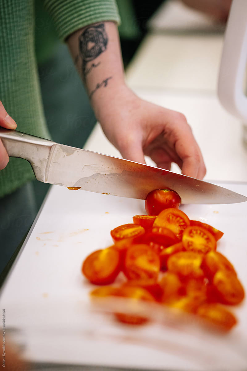 Cooker slicing vegetables for meal