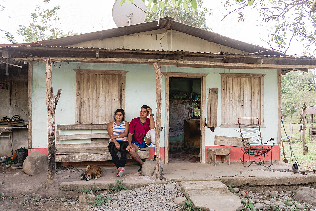 Latin American couple resting in the corridor of their home.