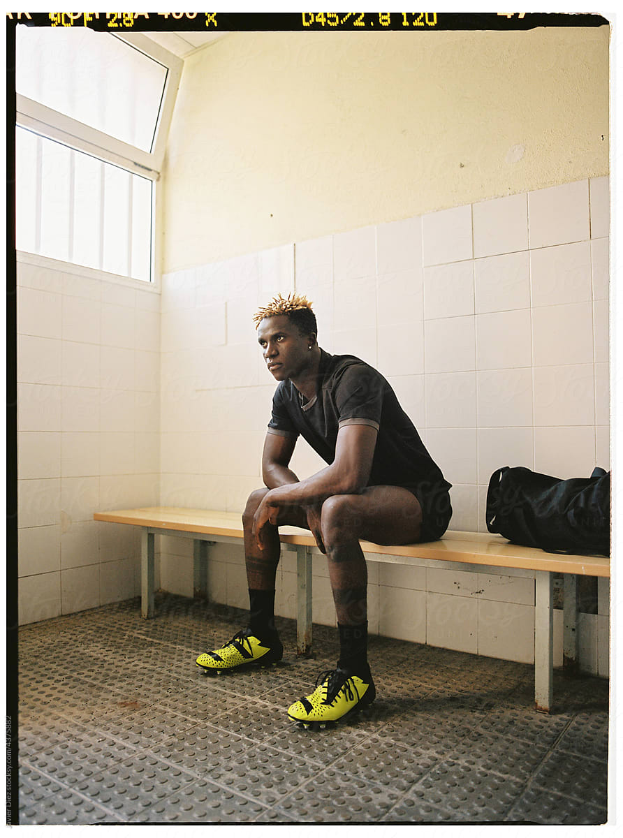 Black male footballer in changing room