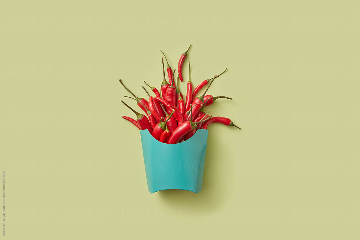 Light blue paper cup full of fresh chili peppers
