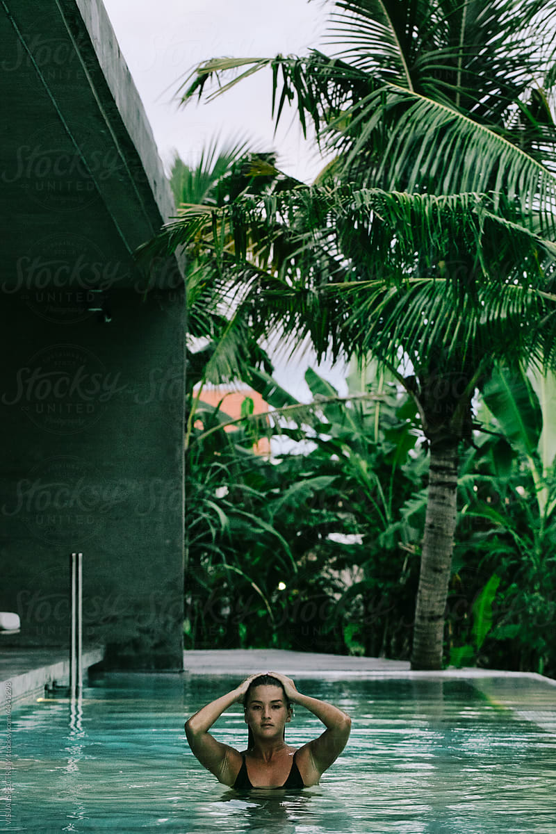 Young Woman Posing in Tropical Pool