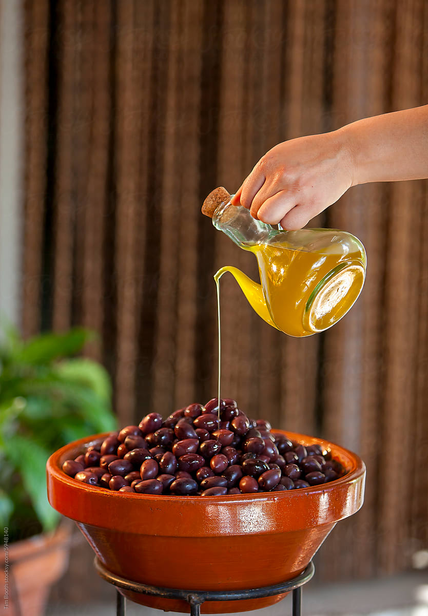 Pouring oil onto olives
