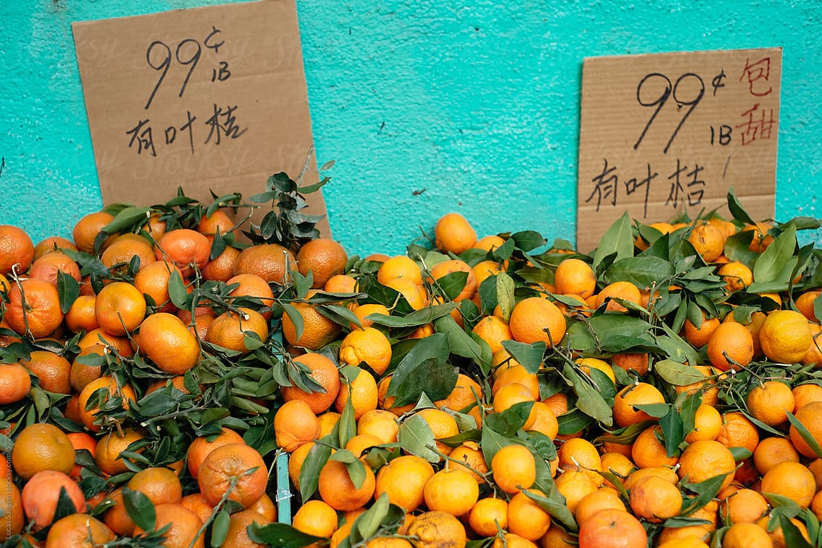 Piles of oranges at an outdoor store.