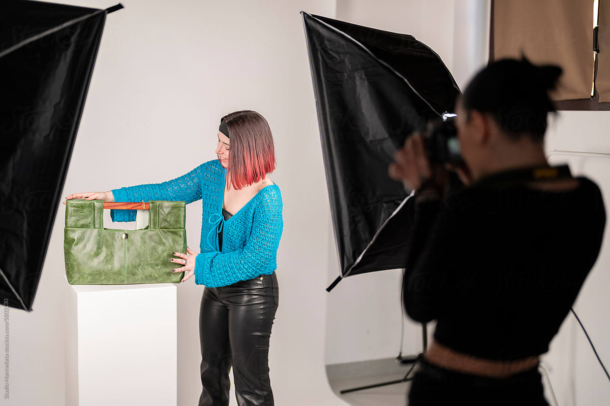 Unrecognizable woman standing with bag in photo studio
