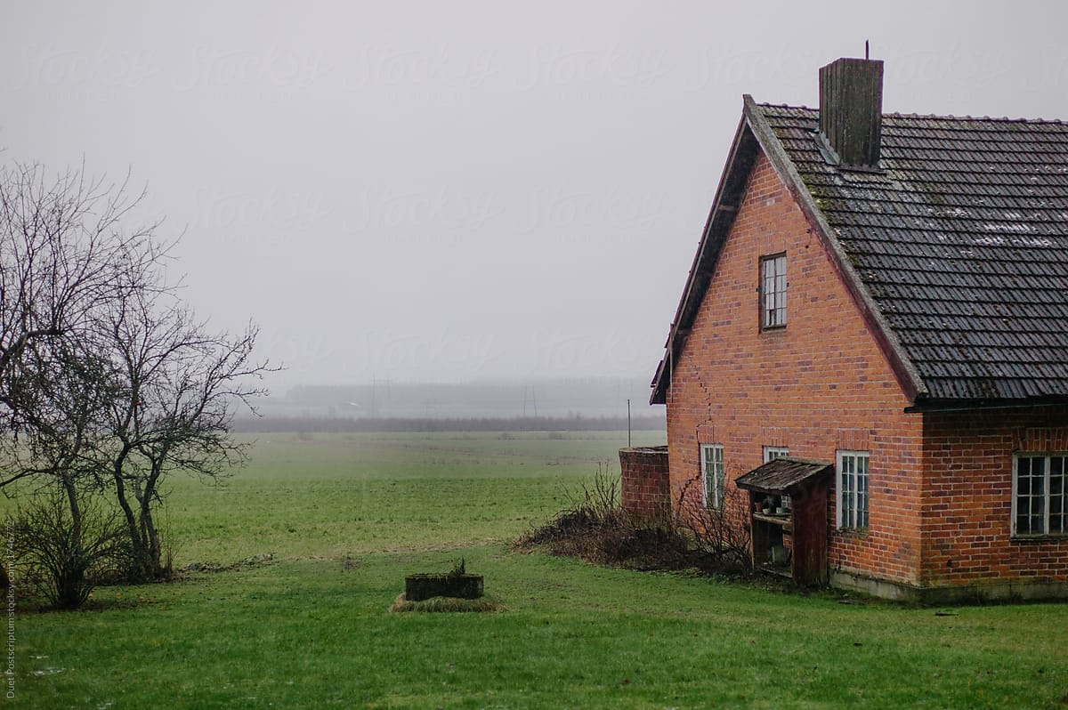Brick house in a foggy field