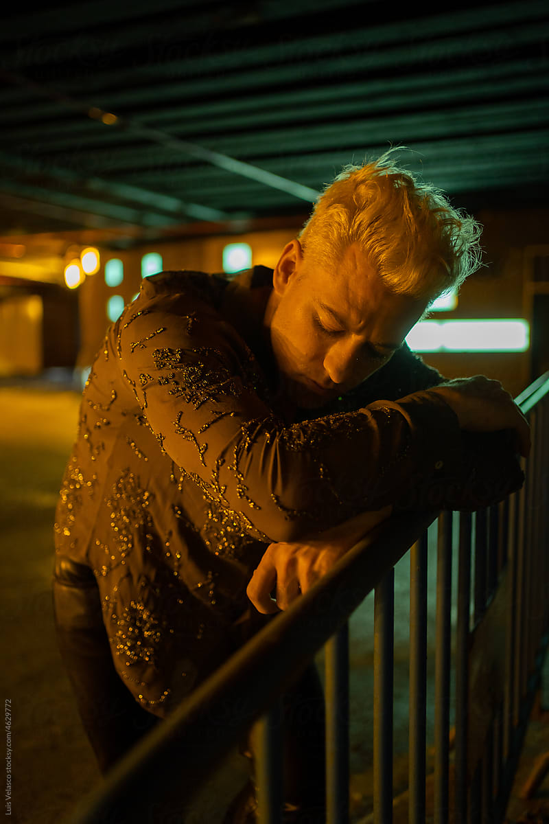 Depressed Blonde Man Feeling Alone Outdoors At Night.