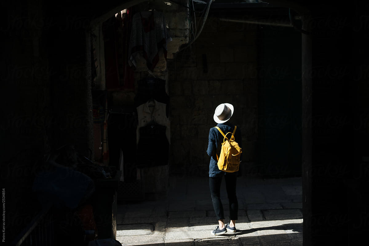 Anonymous woman on old street near market