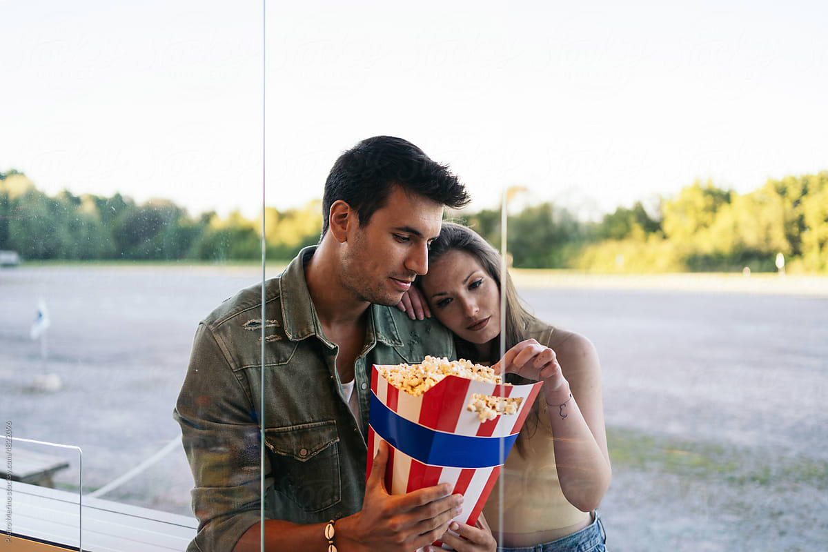Couple buying popcorn at outdoor summer cinema
