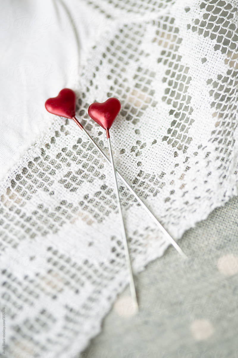 Heart shaped sewing pins on vintage lace