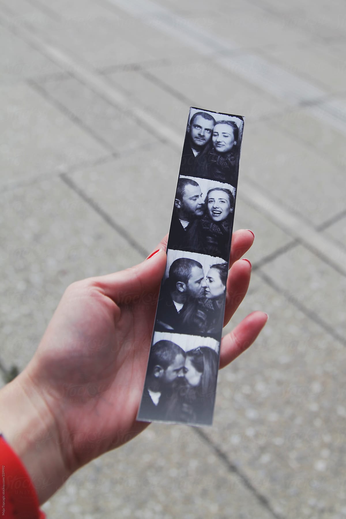 Woman holding an instant photo of a couple