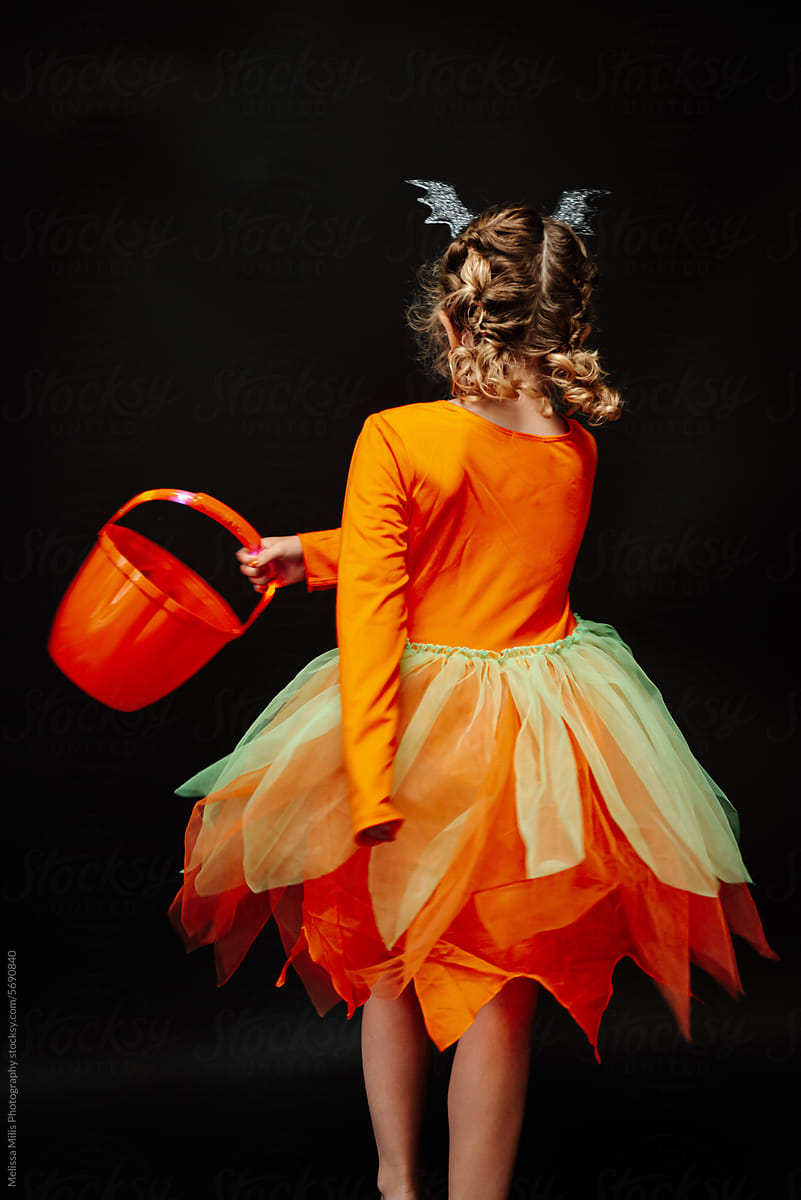 Portrait of girl with halloween costume dress making a swirl