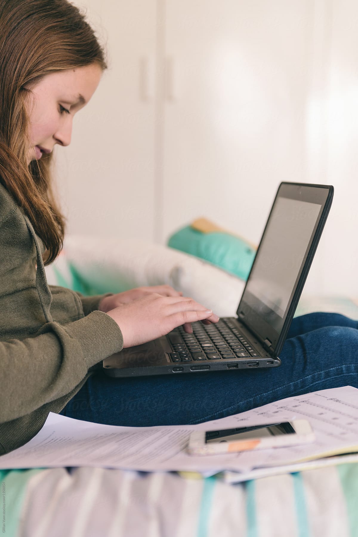 Teen Girl Doing Homework On Her Laptop In Her Bedroom By Stocksy Contributor Gillian Vann 2499