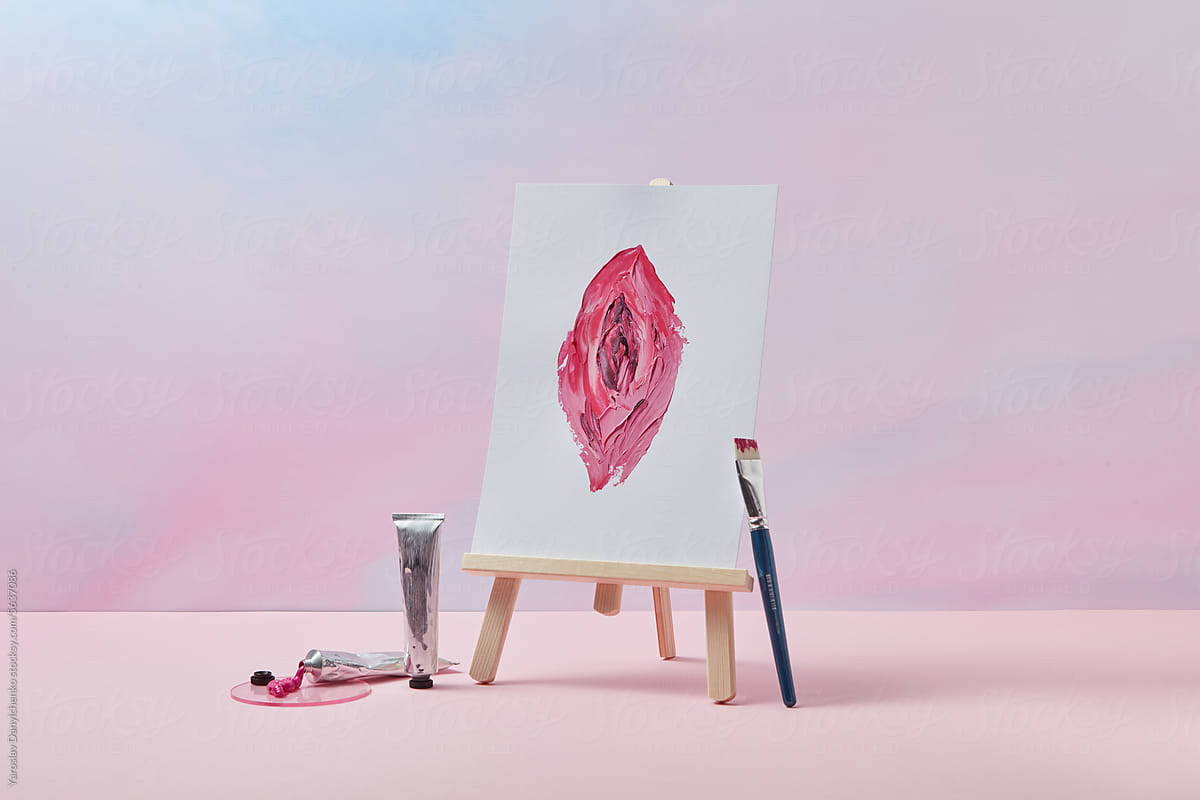Easel with painted woman\'s vagina on canvas in studio