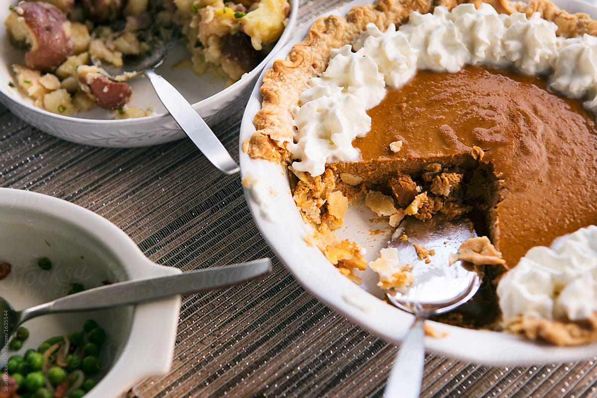 Thanksgiving: Half Eaten Pumpkin Pie On Table