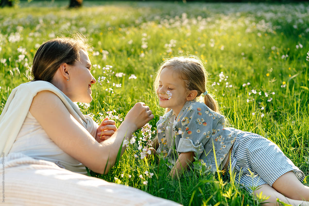Mother and daughter playing with flower