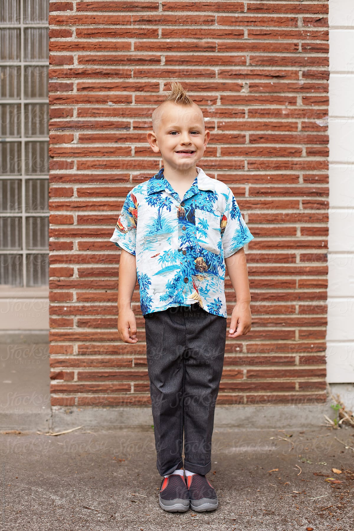 Boy with mohawk wearing Hawaiian shirt on first day of Kindergarten