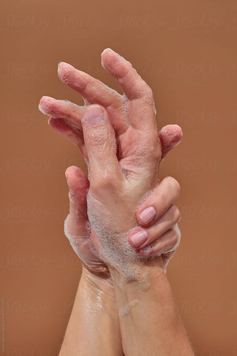 Crop woman showing foamy hands