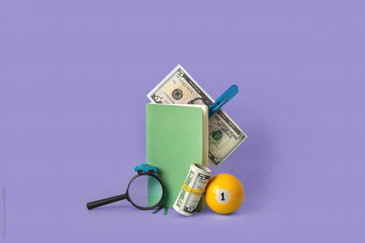 Copybook, magnifier, billiard ball and money