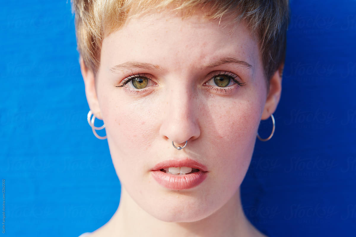 Blonde haired girl with pixie haircut and septum.