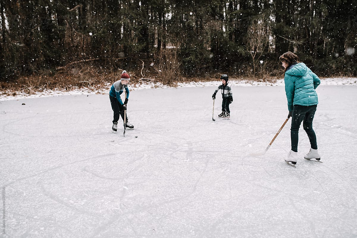 kids playing hockey on frozen pond