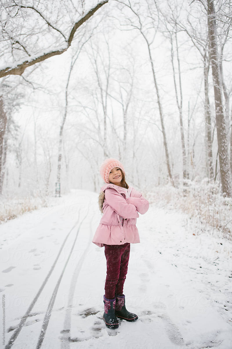 girl poses in winter woods