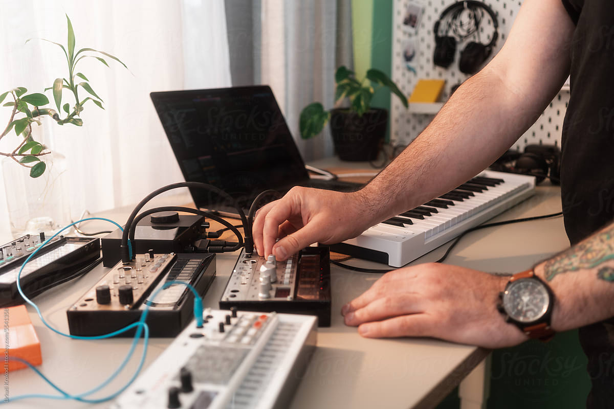 Anonymous Man Playing Music On Synthesizers