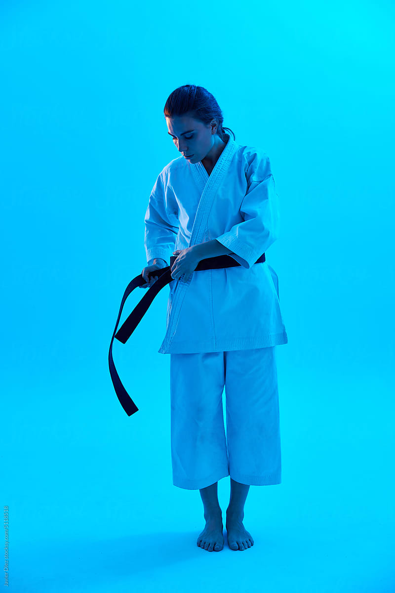 Female fighter tying belt