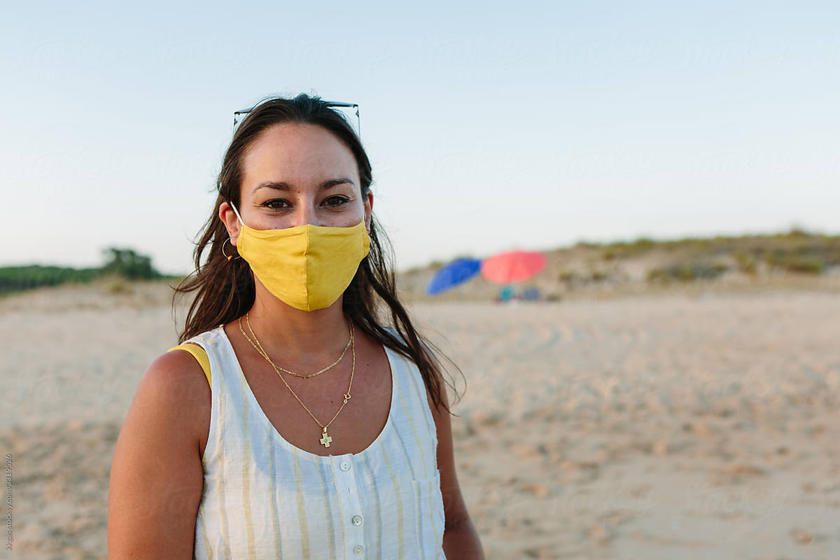 Woman on beach with face mask