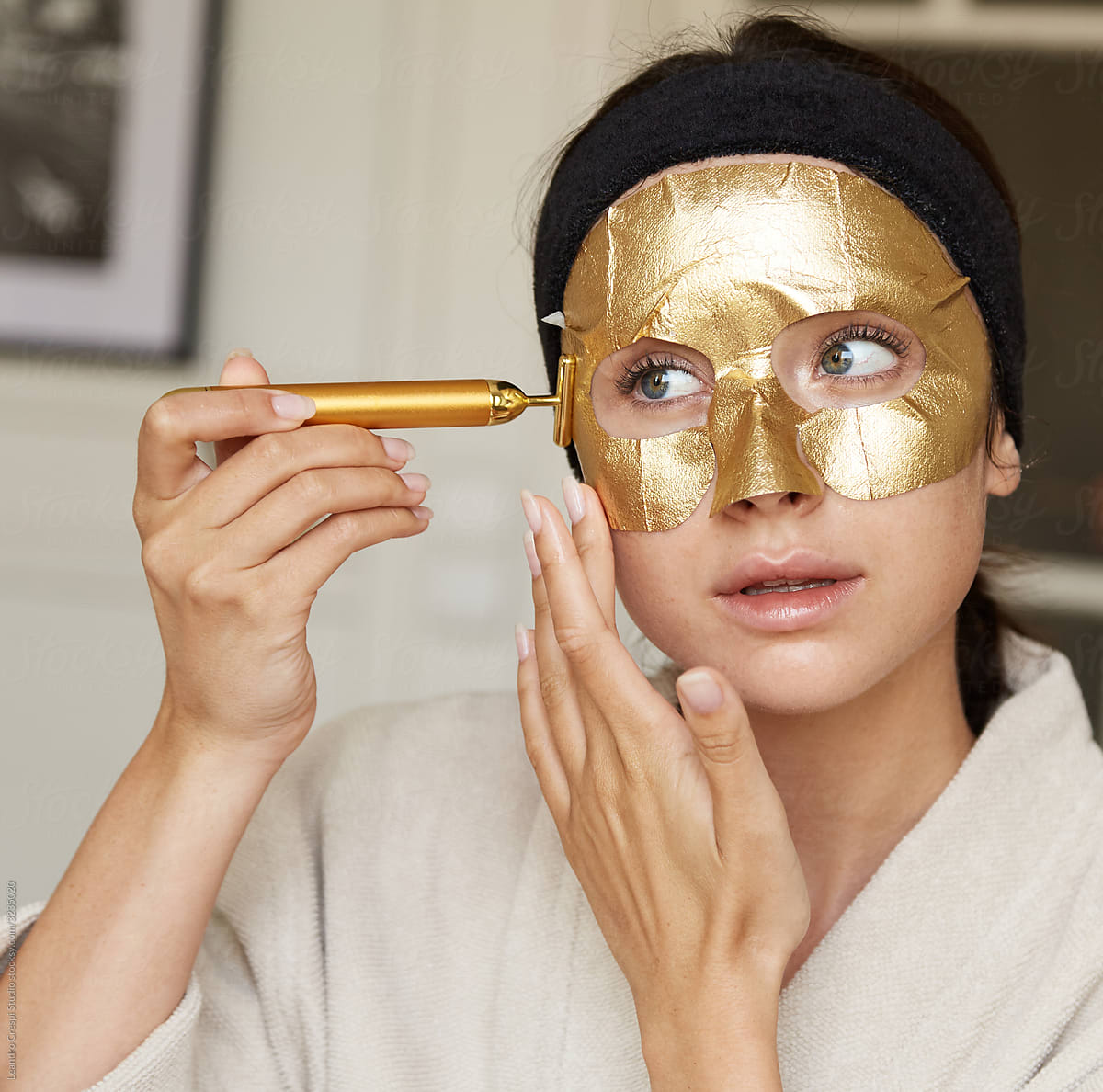 Young woman using gold beauty bar