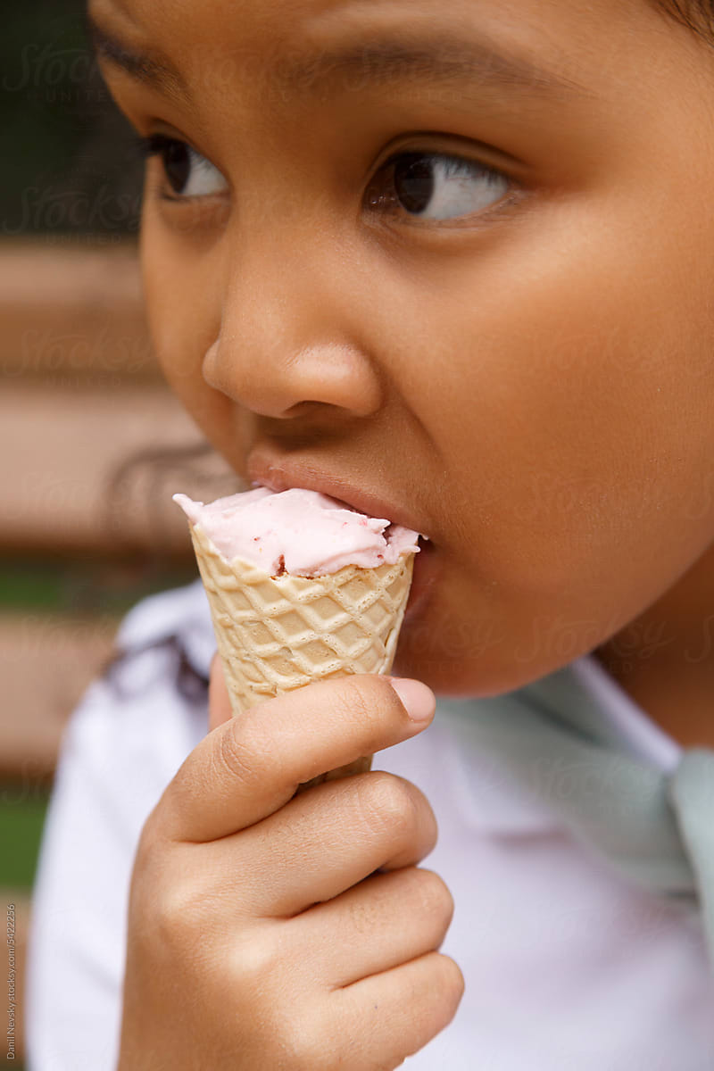 Adorable girl eating tasty ice cream