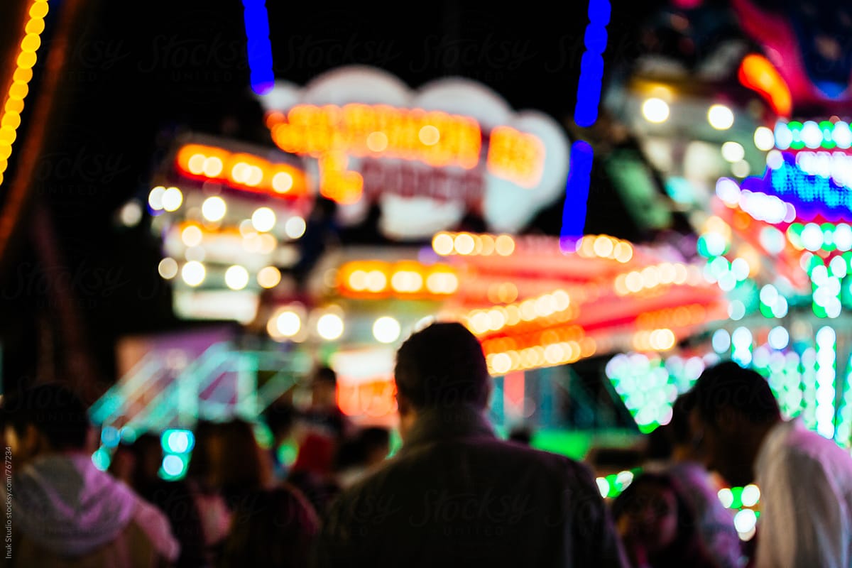 Blurred people in a fair at night